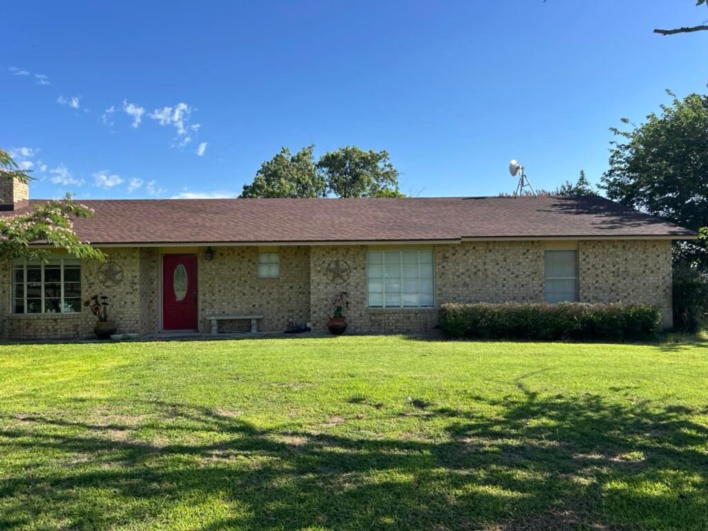 One-story brick house with a new asphalt shingle roof in Abilene, TX.”